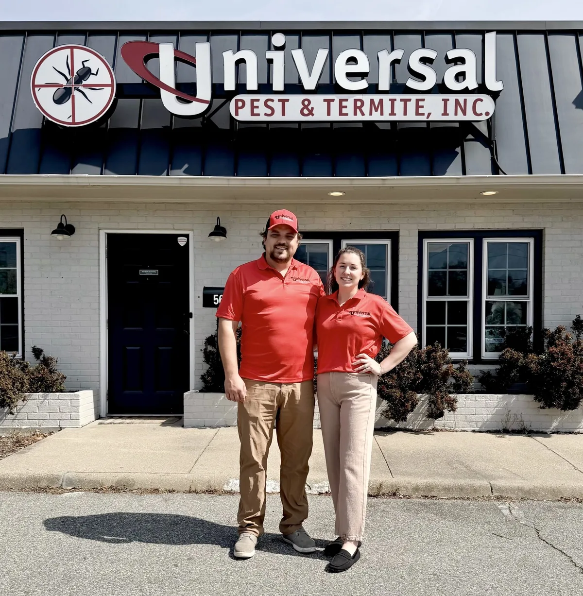 Apicture of Universal Pest & Termite owners Brittany Baine and Tanner Baine in front of the Universal Pest & Termite office in Virginia Beach.