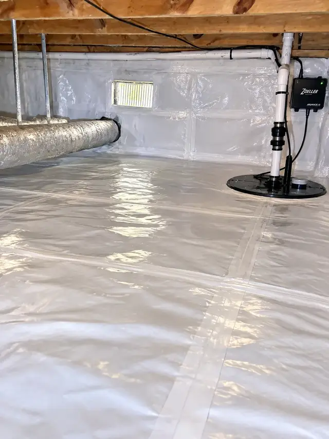 Finished Hampton Roads crawl space with a sealed white liner and a covered sump pump basin.