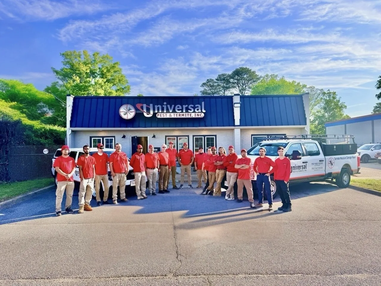 The Universal Pest & Termite team standing in front of service trucks at 5600 Greenwich Rd, Virginia Beach, VA.