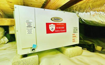 Professional Aprilaire crawlspace dehumidifier with a branded Universal Pest & Termite Dehu-Guard shield installed on concrete blocks over a clean vapor barrier in a Woodard Mill home in Chesapeake, VA
